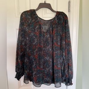 Gorgeous sheer long sleeved blouse with attached cami.